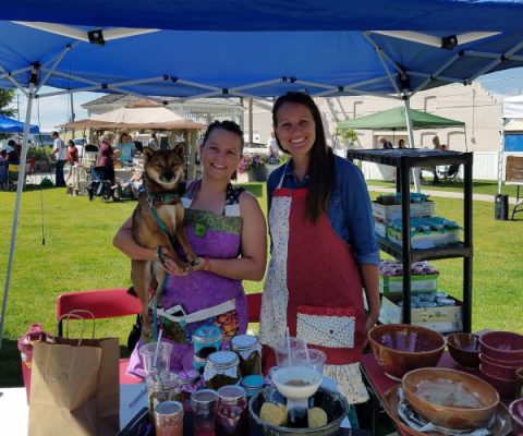 Sisters Anna and Sally Gray, with their dog, at the Jovial Java’s table at the Jackalope Square Farmers Market
